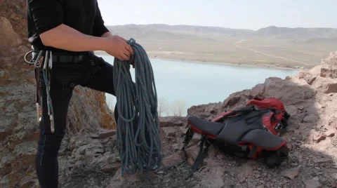 Climber ties the rope to its safety systems Stock Footage 61284357