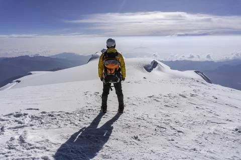 A climber on the top of a mountain Stock Photos
