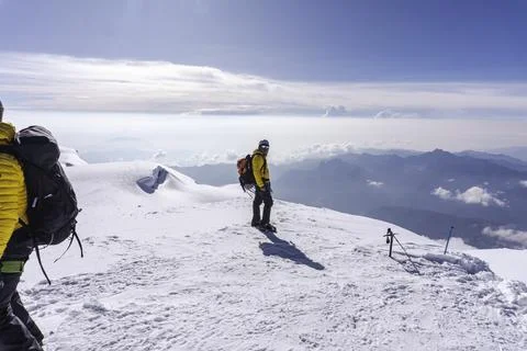 A climber on the top of a mountain Stock Photos