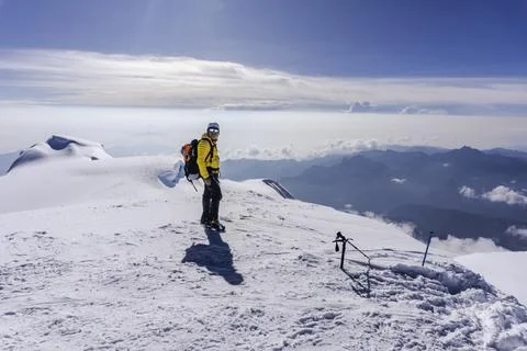 A climber on the top of a mountain Stock Photos