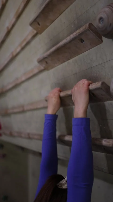 Climber trains grip strength on a campus board Stock Footage 339287687