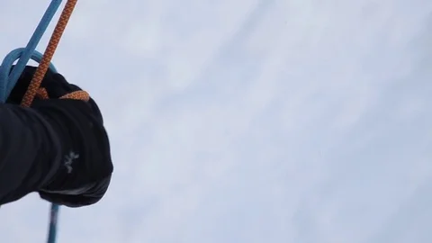 Climber tying a knot with rope before climbing a snowy mountain Stock Footage 73621699