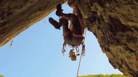 Climber uses knee to make difficult move Stock Footage 29356255