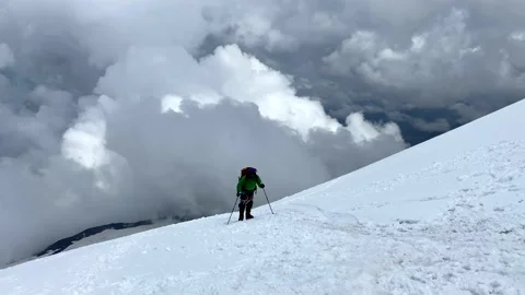 Climber walks along a snowy path to Elbrus Stock-Footage 135515671