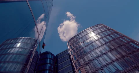 Climber window cleaner doing his job on the glass walls of the business center Stock Footage 119616886