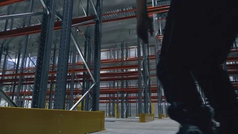 Climber without insurance on rollers in the logistics center Video stock 104307108