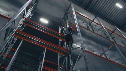 Climber without insurance on rollers in the logistics center Video stock 104307128
