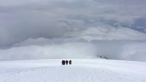 Climbers climb the mountain through the clouds. Stock Footage 101727981