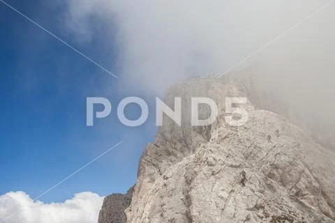 Climbers in a cloudy day few meters above the Sass de Putia peak, in Dolomite Stock Photos