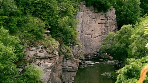 Climbers to conquer the rock above the rive Stock Footage 97650600