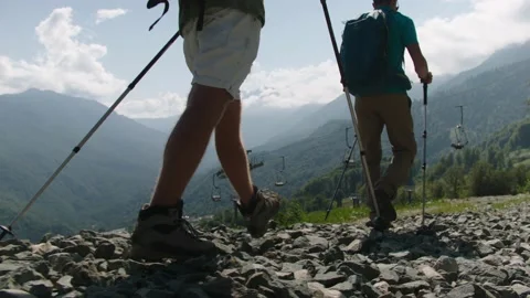 Climbers move under cable car for ski lifts, switched off for the summer time Stock Footage 208878219