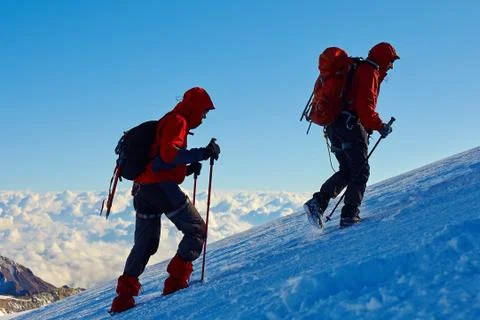 Climbers at the top of a pass Stock Photos