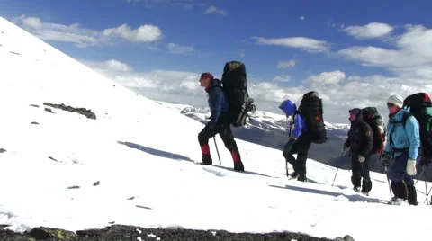 Climbers walk on snow mountain. Stock Footage