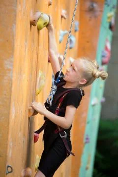 Climbing up the bouldering wall Stock Photos