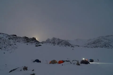 Climbing camp high in the mountains. Moonlight. Stock Photos