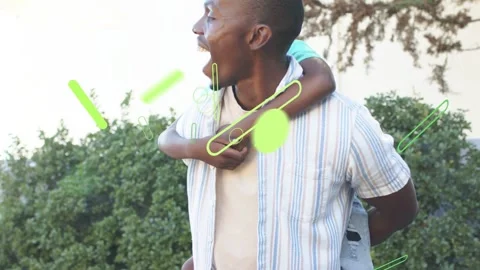 Climbing child wrapping arms around dad's back in yard, dad carrying for fun, Stock Footage 332934332