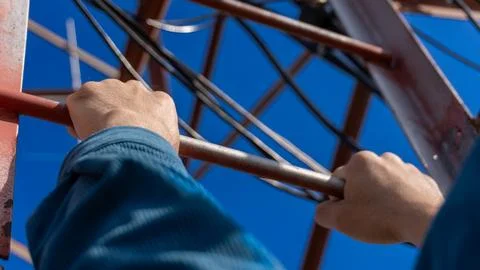 Climbing a communication tower with a view from first-person perspective Stock Photos