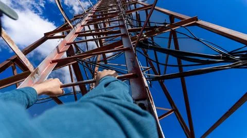 Climbing a communication tower with a view from first-person perspective Stock Photos