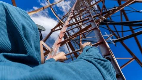 Climbing a communication tower with a view from first-person perspective Stock Photos