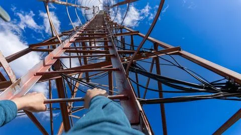 Climbing a communication tower with a view from first-person perspective Stock Photos