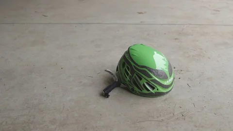 Climbing helmet lying on the floor Stock Footage 83867103