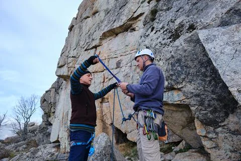 A Climbing instructor explains how to make a belay station Stock Photos