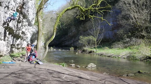 Climbing the limestone gorge by the the River Wye at Chee Dale Stock Footage 308757346