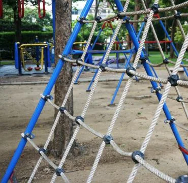 Climbing the net at the playground Stock Photos