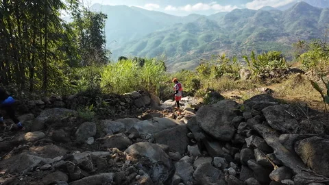 Climbing over rocks and obstacles in the mountains of Vietnam Stock Footage 296266556