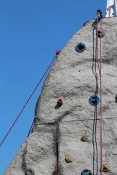 Climbing rock in front of blue sky Stock Photos