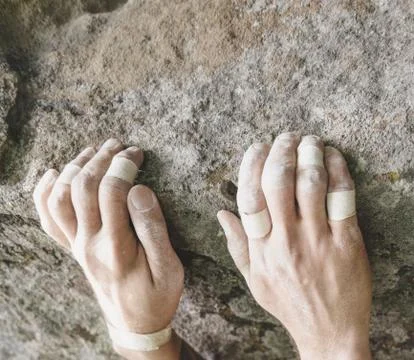 Climbing on rock, view of hands. Stock Photos