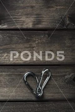 Climbing rope and carabiner on wooden board Stock Photos