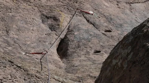 Climbing rope fastened to the rock with the help of the insurance points Stock Footage 61652293