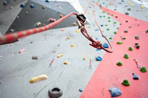 Climbing. A safety bolt threaded a rope with a carbine. Granite wall Stock Photos