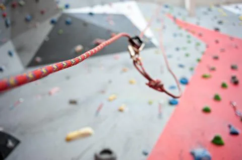 Climbing. A safety bolt threaded a rope with a carbine. Granite wall Stock Photos
