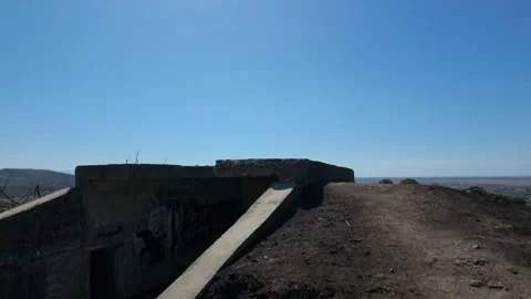 Climbing a second World War bunker with burned earth all around it Stock Footage 347274647