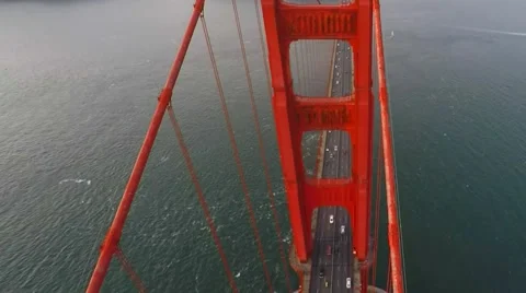 A climbing shot looking down at traffic on the Golden Gate bridge Stock Footage 60991315