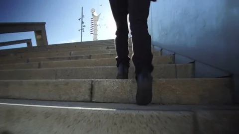 Climbing a stairs, low angle shot. Video stock 84901993