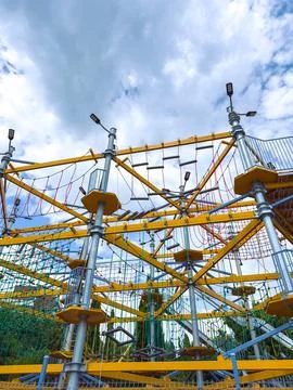 Climbing structure with ropes and nets in an outdoor playground in bright d.. Stock Photos