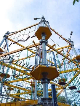 Climbing structure seen in a park on a cloudy day with various ropes and pl.. Stock Photos