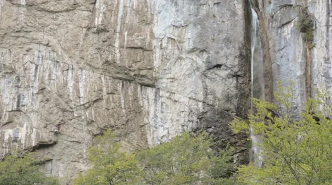 Climbing team next to huge waterfall Stock Footage 43759788