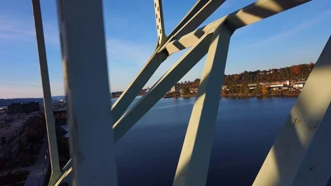 Climbing up the truss of tall freeway bridge to pan sideways at high speed Stock Footage 118874899