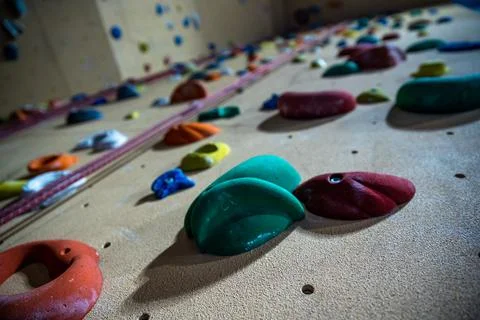 Climbing wall with different colored handles in a modern gym Stock-Fotos