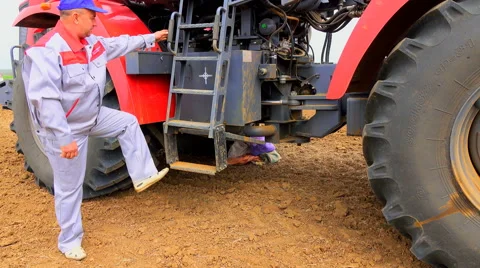 Climbs to the tractor Stock Footage 62784943