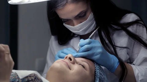 In the clinic, the cosmetologist does the client a mechanical facial cleansing 스톡 동영상 81637026