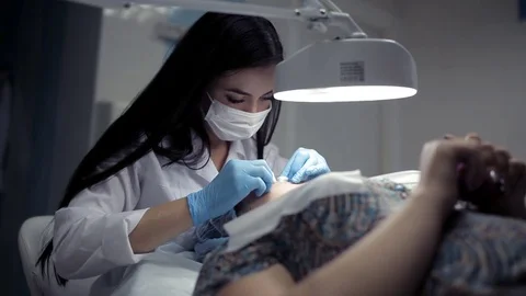 In the clinic, the cosmetologist does the client a mechanical facial cleansing Video stock 81637236