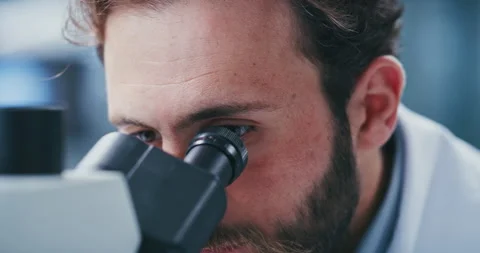 Clinic, scientist and man with microscope, analysis and study for vaccine, exam Stock Footage 330039354