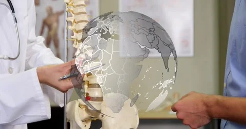 Clinician moving pointer along lumbar spine as rotating globe animating area for 動画素材 317842120
