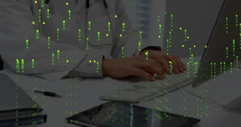 Clinician typing on keyboard and causing green numeric overlay pulsing during Stock Footage 312712593