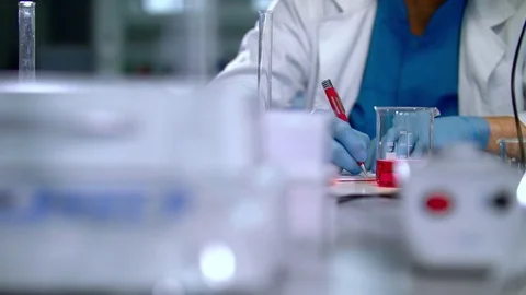 Clinician writing down test report in lab environment. Scientist writing data Stock Footage 72165405